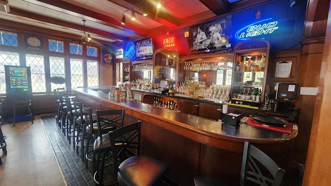 The historic carved gum-wood bar at On The Clock Bar & Grill